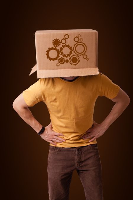 Young man standing and gesturing with a cardboard box on his head with spur wheels