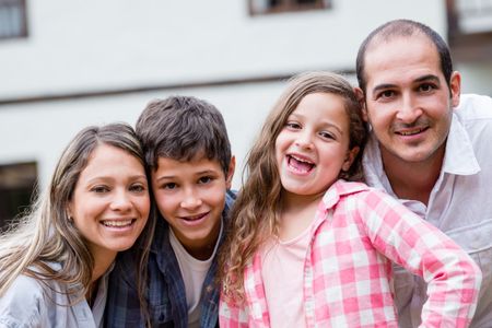 Portrait of a happy family having fun outdoors