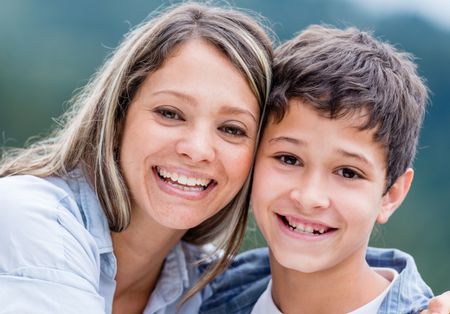 portrait-happy-mother-son-smiling-outdoors-140022802 Portrait of a happy mother and son smiling outdoors