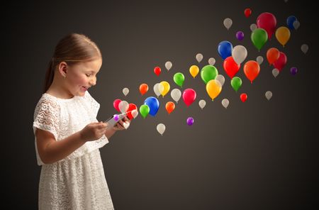 Cute little girl using tablet with colourful balloons concept