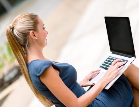 Successful business woman using a laptop computer