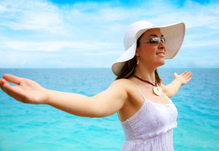 beach freedom woman with arms open enjoying peace and tranquiity