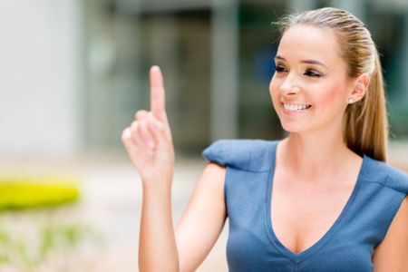 Business woman pointing with her finger touching an imaginary screen