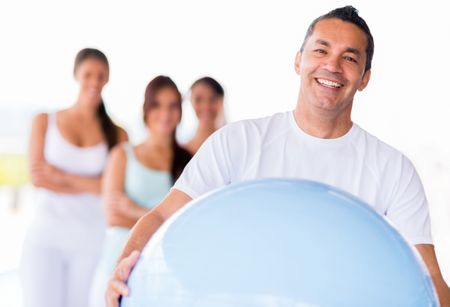 Portrait of a man with Pilates ball looking happy