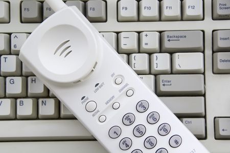 Mobile telephone on top of computer keyboard