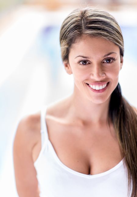 Portrait of a young woman smiling outdoors