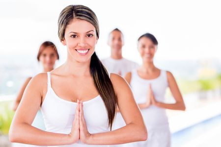 Woman in a yoga class with a group of people