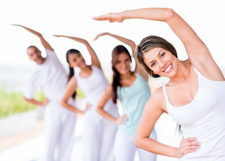 Group of people practicing yoga and smiling