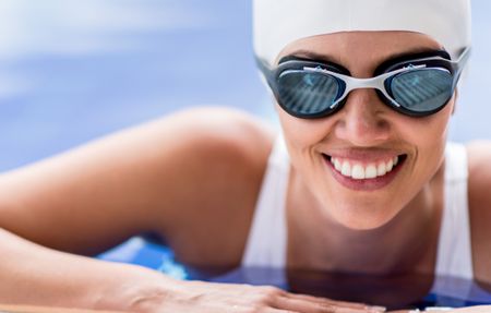 Portrait of a female swimmer smiling in the pool