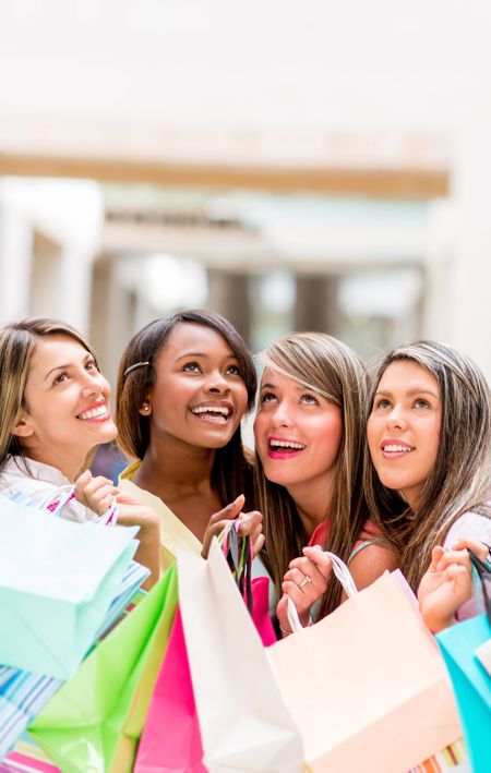 Group of shopping women looking up daydreaming