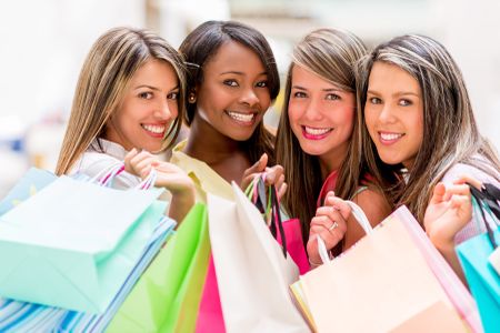 Group of shopping women holding bags ant looking happy