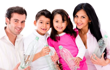 Happy family recycling plastic bottles - isolated over white