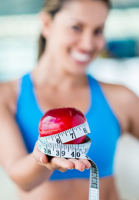Healthy eating woman holding apple and loosing weight