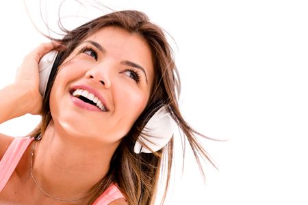 Woman listening to music with headphones - isolated over white