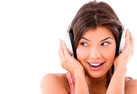 Happy woman listening to music with big headphones - isolated