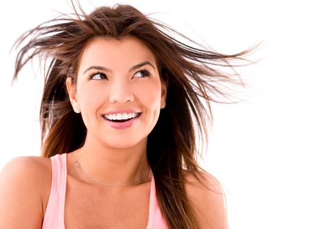 Thoughtful woman having fun with her hair in the wind - isolated