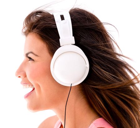 Happy woman listening to music with headphones - isolated over white