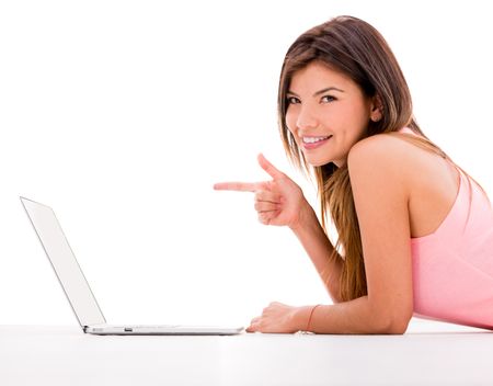 Woman pointing at a laptop computer - isolated over white background