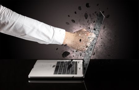 Strong male hand breaks laptop screen glasses