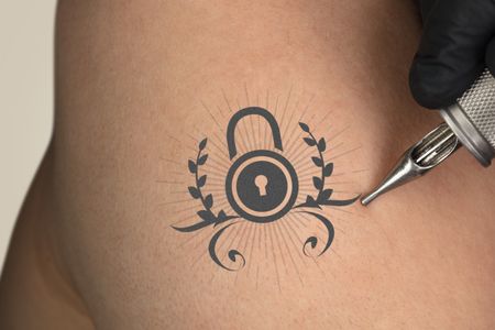 Hand tattooing colorful communication, leadership and creativity concept on naked clear skin