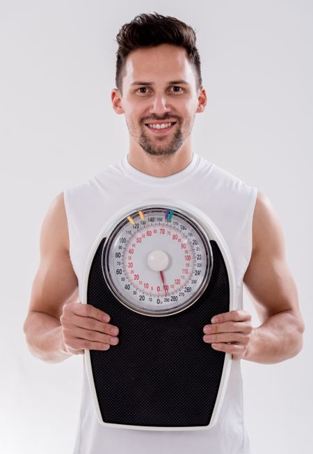 Portrait of a gym man with weight scale