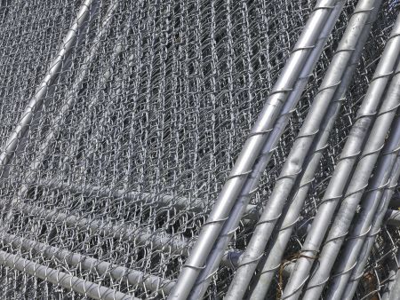 Barriers in abundance: Stack of chain-link fencing on construction site