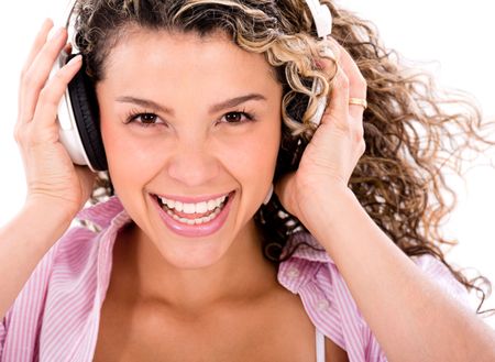 Happy woman listening to music with headphones - isolated over white