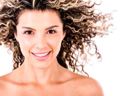 Beautiful woman portrait with curly hair and smiling - isolated over white background