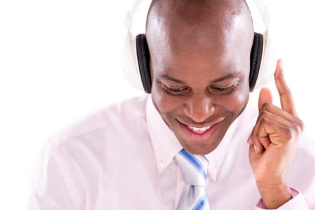 Business man listening to music with headphones - isolated over white