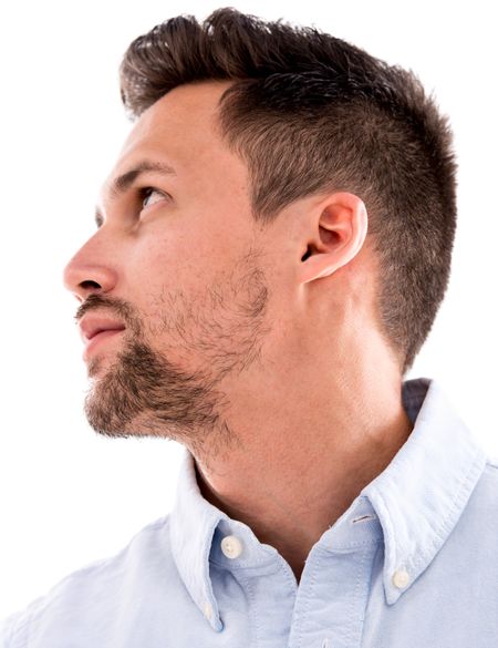 Casual man portrait looking up to the side - isolated over a white background