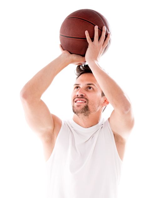 Male basketball player shooting the ball - isolated over black