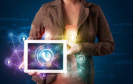 Young lady showing social networking technology with colorful lights