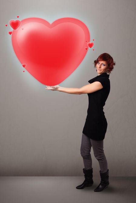 Beautiful young lady holding lovely 3d red heart