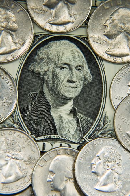 George Washington's face surrounded by quarters on U.S. dollar bill