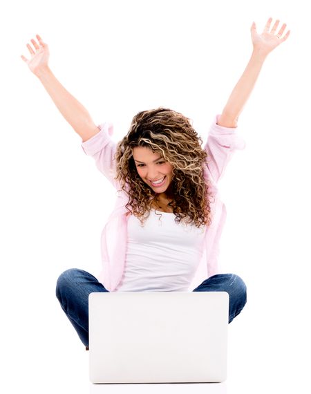Successful woman with a laptop computer and arms up - isolated over white