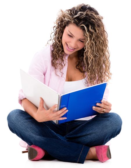 Woman studying and reading her notebook - isolated over a white background 