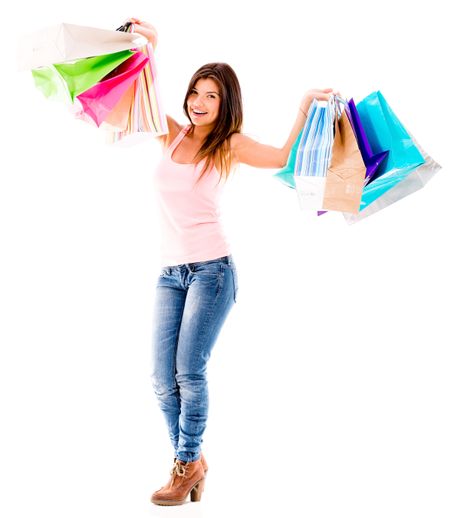 Happy shopping woman holding bags - isolated over a white background 