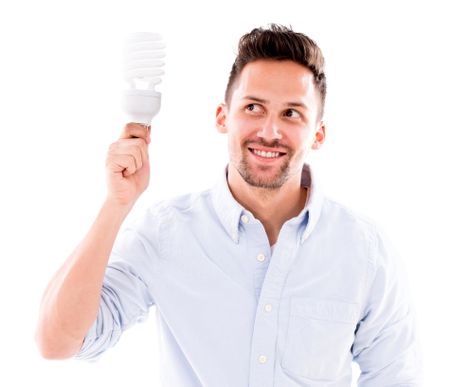 Man thinking of an idea holding an energy saving bulb - isolated over white