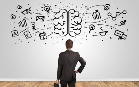 Angry manager looking to wall with drawn overloaded brain concept