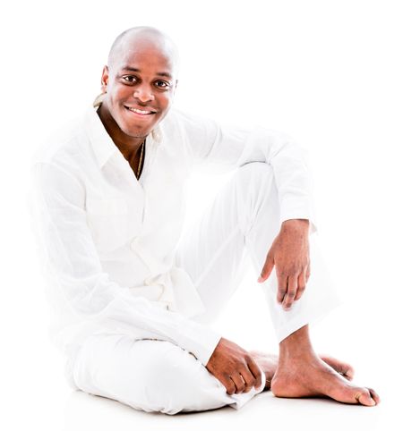 Peaceful black man wearing white and smiling - isolated 