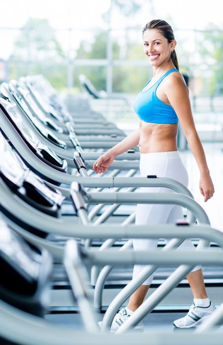 Woman walking on a treadmill at the gym