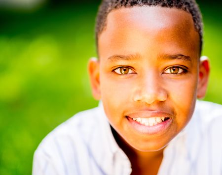 Portrait of a happy black boy smiling at the park