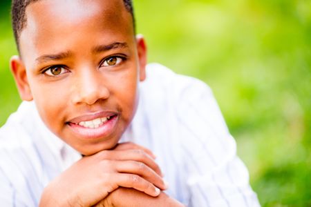 Beautiful portrait of an African American boy smiling outdoors