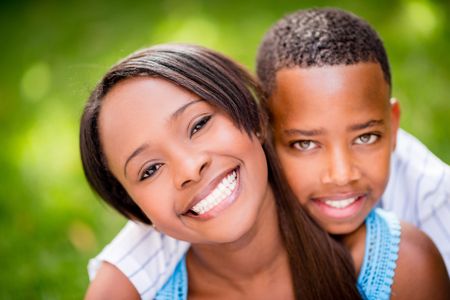 Beautiful portrait of a mother and son smiling outdoors