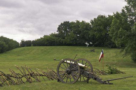 Confederate cannon pointing across mock battlefield before reenactment of battle in American Civil War (1861-1865), Lombard, Illinois