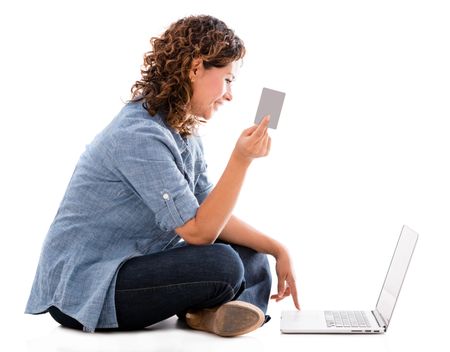 Woman shopping online with a credit card - isolated over white