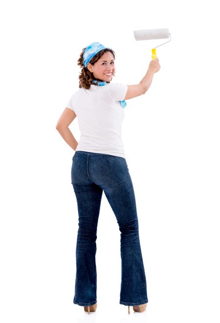 Casual woman painting a white wall with a paint roller - isolated