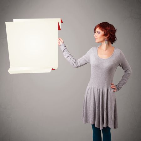 Baeutiful young woman holding white origami paper copy space