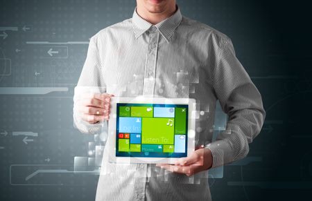 Young businessman holding a tablet with modern software operational system