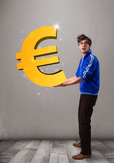 Good-looking young boy holding a big 3d gold euro sign
